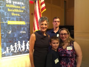 Jeanieann Ferrari (right), her husband and one of her four children pose with former U.S. Rep. Allyson Schwartz (left) at the 50th Anniversary of Medicare and Medicaid at the National Constitution Center.