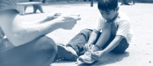 Kids tying shoes on the playground